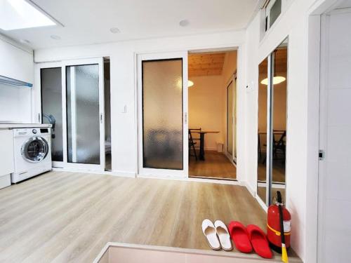 a living room with red flip flops on the floor at Sam House 2 Seochon in Seoul