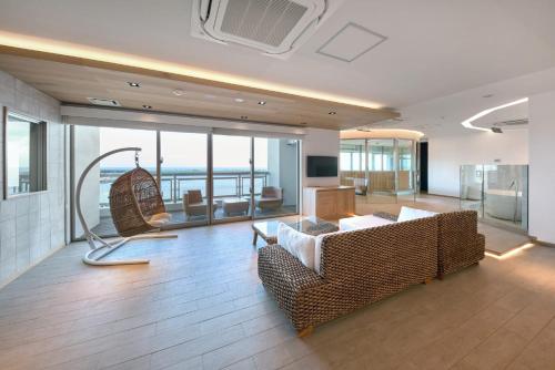 a living room with a couch and a chair in a building at THIRD ishigakijima in Ishigaki Island