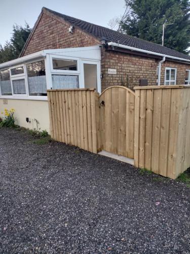 a wooden fence in front of a house at Rosedene in Mablethorpe