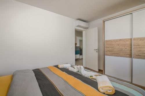 Schlafzimmer mit einem Bett und einem großen Glasfenster in der Unterkunft Apartments Sunrise Krk in Krk