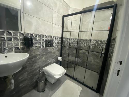 a bathroom with a toilet and a sink at Bakırköy Macro Suite Otel in Istanbul