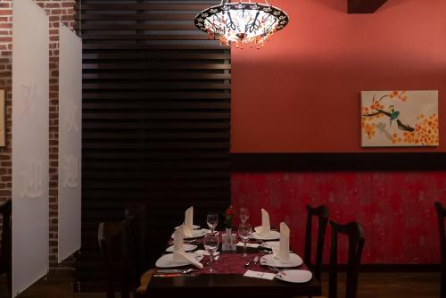a dining room with a table and a chandelier at Adalya Art Side - Ultra All Inclusive in Side