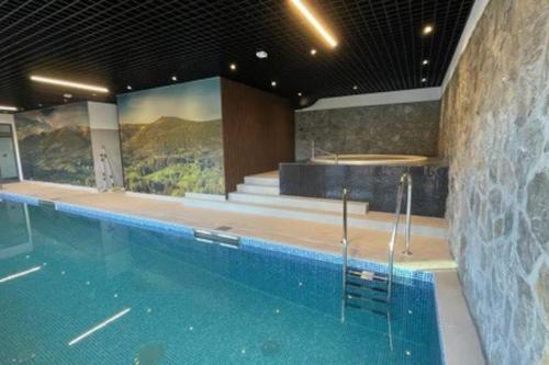 a large swimming pool with a swimming at C4 Podgrzewany basen sauna, nowy Revist Szklarska in Szklarska Poręba