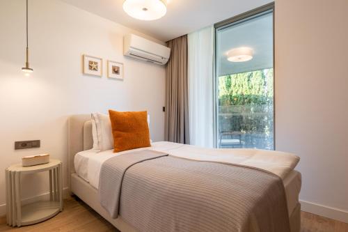 a bedroom with a bed and a large window at Hiddenbay Teos Sığacık Hotel, Spa and Restaurants in Seferihisar