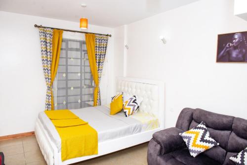 a bedroom with a bed and a chair at LN EXECUTIVE FURNISHED WEST STUDIOs in Nairobi