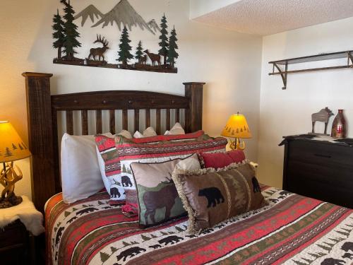 a bedroom with a bed with pillows on it at Lifts West 208 With Wifi in Red River