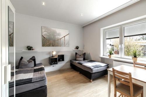 a bedroom with a bed and a desk in a room at Haus KÖ 17 in Norderstedt