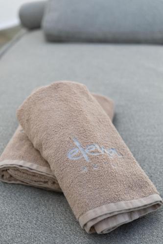 a pile of towels sitting on the floor at Elena Hotel Mykonos in Mýkonos City