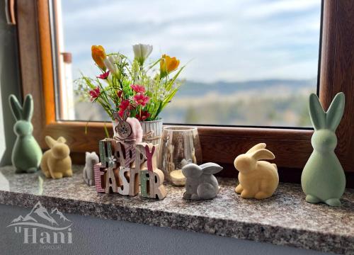 a group of bunny figurines sitting on a window sill at Pokoje u Hani - sauna, balia z hydromasażem in Bukowina Tatrzańska