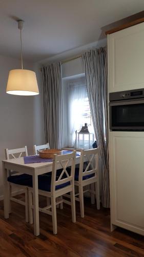 a kitchen with a table and chairs and a window at Haus Guentli in Mittelberg