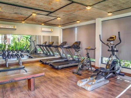 a gym with a row of exercise bikes at Title III and II by Villacarte in Rawai Beach