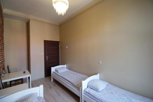 Łóżko lub łóżka w pokoju w obiekcie Vanilla Hostel Wrocław