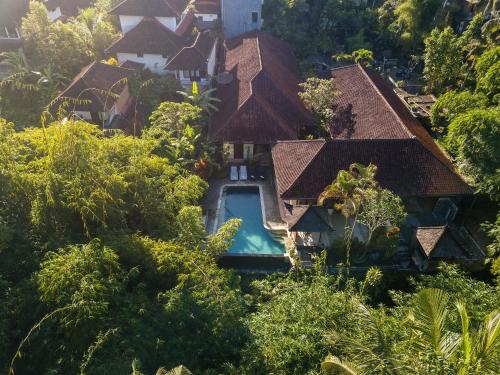 an aerial view of a house with a swimming pool at The Tunjung Ubud Retreat in Ubud