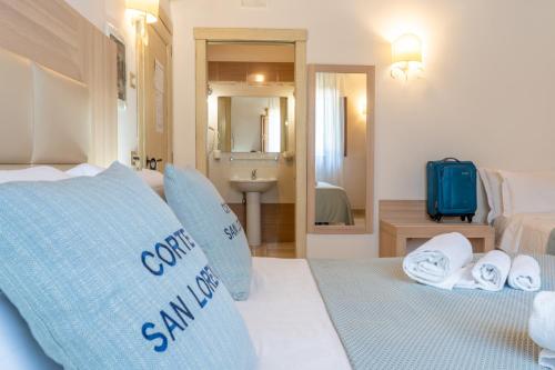 a hotel room with a bed with towels on it at Corte San Lorenzo in Sant'Egidio del Monte Albino
