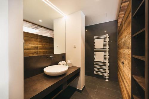 a bathroom with a white sink on a counter at Torghele's Wald & Fluh in Balderschwang