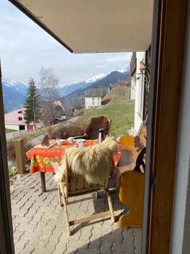 a room with a table with a view of a mountain at Hoch über dem Rheintal in Brigels
