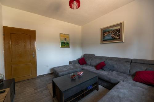 a living room with a couch and a table at Lucija in Starigrad-Paklenica