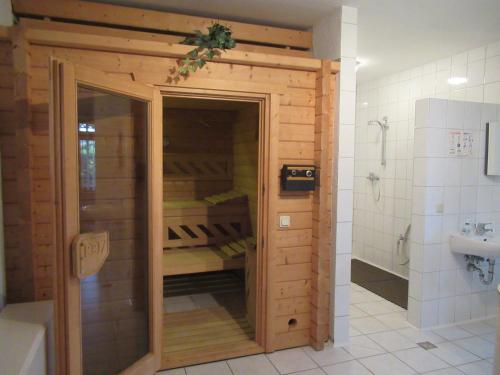 a bathroom with a wooden closet in a bathroom at Feriendorf Mengshausen in Niederaula
