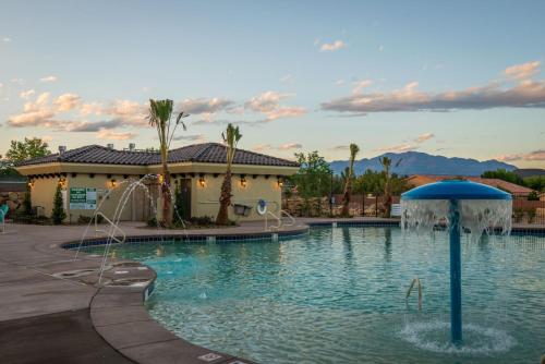 a swimming pool with a fountain in a resort at W307 Third Floor 3-bedroom Pool View in St. George