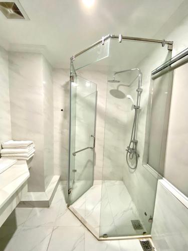 a bathroom with a shower with a glass door at Asean Hotel in Hải Dương