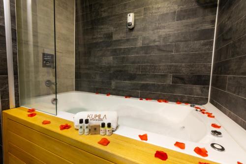 a bathroom with a bath tub with red roses on it at Kuhla Hotel in Trabzon