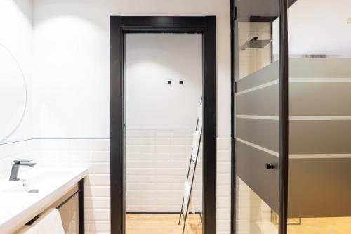 a glass shower door in a bathroom at Hotel Boutique Puerta de las Granadas in Granada