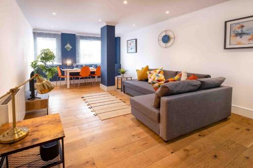 a living room with a couch and a table at Riverside House Bristol in Bristol