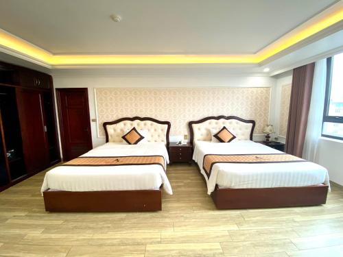 a hotel room with two beds in a room at Asean Hotel in Hải Dương