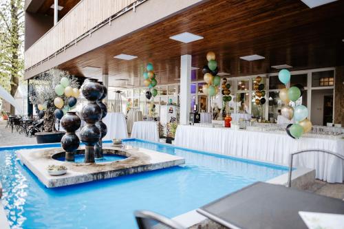 a pool with a fountain in the middle of a building at Hotel Fontána in Brno