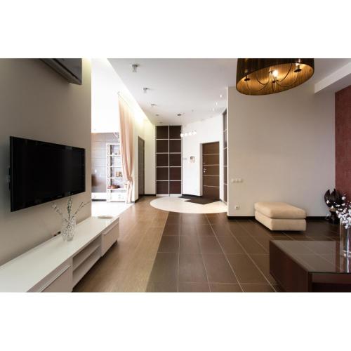 a large living room with a flat screen tv at Naykova district Apartments in Kharkiv