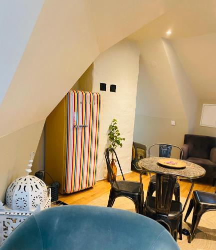 a living room with a table and a large suitcase at Lomma Station Inn Loft in Lomma