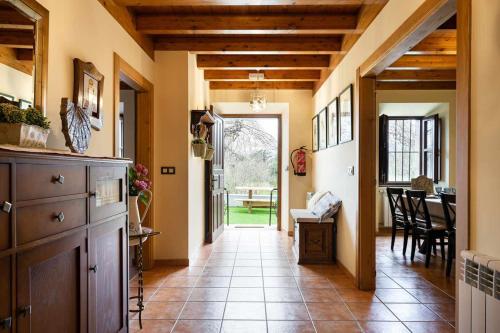 a hallway of a home with a table and a dining room at Casa rural la javariega in Ribadedeva