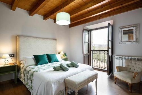 a bedroom with a large bed and a window at Casa rural la javariega in Ribadedeva