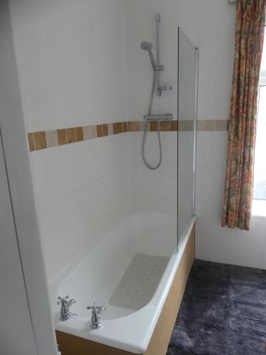 a bathroom with a sink and a glass shower at Rowland House - Central Skipton, Dales Gateway in Skipton