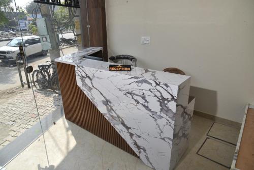 a marble counter in front of a building at APEX HOTEL in Amritsar