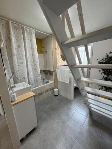 une salle de bain avec un lavabo et une baignoire dans l'établissement Duplex paisible à la campagne, à Relans