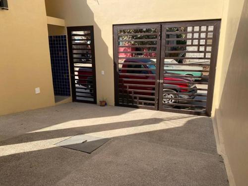 a room with a garage with a car reflection in the window at Casita con Alberca en San Fran. in San Francisco