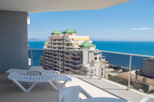 a balcony with a bench and a view of the ocean at Apartamentos Entremares - Grupo Antonio Perles in Calpe