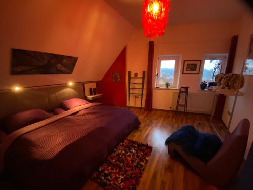 a bedroom with a bed and a chair in it at Ferienwohnung in historischer Villa mit Gartennutzung in Furth im Wald