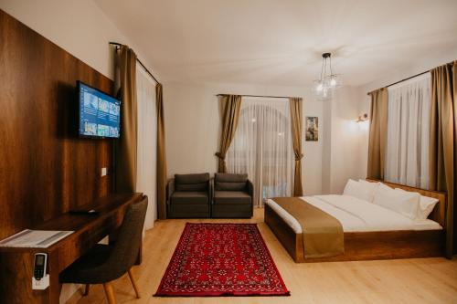 a hotel room with a bed and a desk and a couch at Copper House in Trabzon