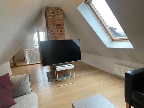 a living room with a large flat screen tv at Apartment in historical house in Oslo