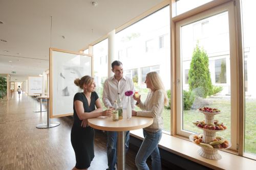 a group of people standing around a table in a building at Hotel St Elisabeth in Allensbach