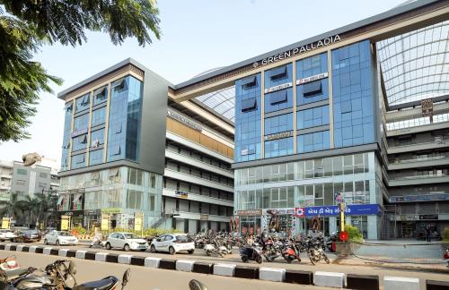 a group of motorcycles parked in front of a building at HOTEL THE PARKER INN By KBNT GROUP in Surat