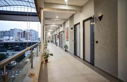 a corridor of an office building with plants on it at HOTEL THE PARKER INN By KBNT GROUP in Surat