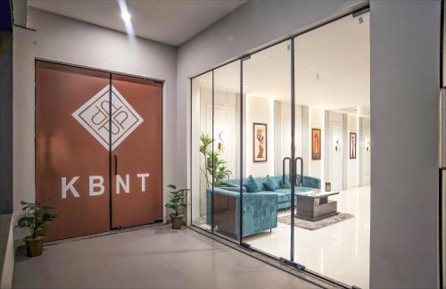 a lobby with a blue couch and a glass door at HOTEL THE PARKER INN By KBNT GROUP in Surat