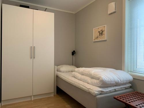 a small bedroom with a bed and a closet at Slåttastølen leiligheter - by Geilolia in Geilo