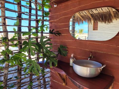 a bathroom with a sink and a mirror at São Francisco Ecopousada in Guriú