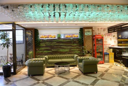 a lobby with a couch and a telephone booth at Style Hotel Sisli in Istanbul