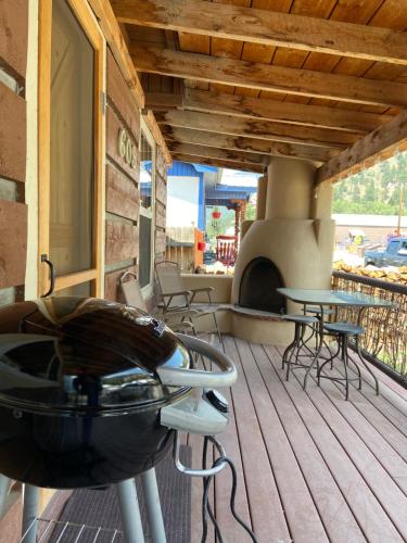 a grill on a porch with a table and chairs at Red And Blue 4 U With High Speed Wifi in Red River