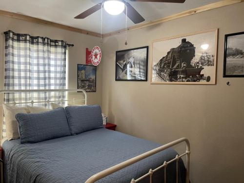 a bedroom with a bed with a train on the wall at Red And Blue 4 U With High Speed Wifi in Red River